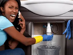 Emergency plumbing repair for a leaking sink drain under a bathroom vanity in Allentown, PA