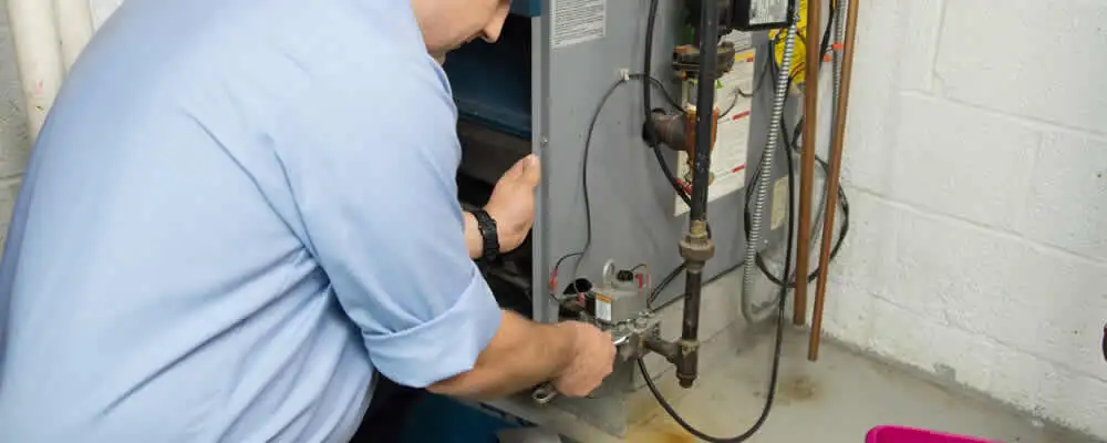 Furnace repair technician inspecting and servicing a home heating system in Allentown, PA