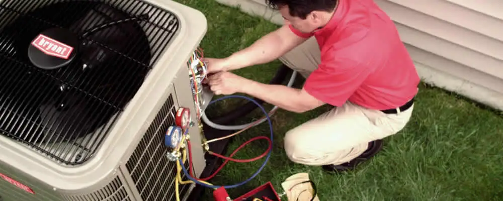 HVAC technician servicing an outdoor air conditioner unit in Allentown, PA
