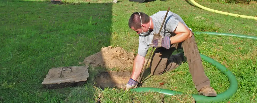 Septic pumping technician servicing a residential septic tank in Allentown, PA